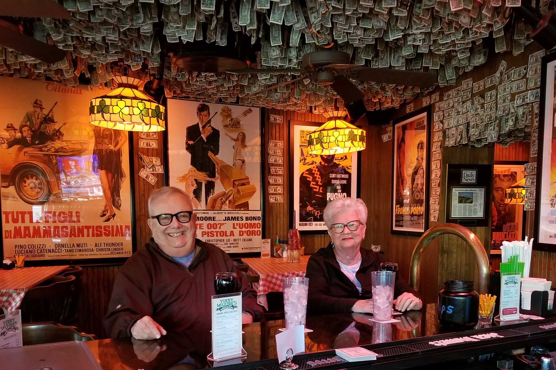 husband and wife seniors sitting at the bar smiling